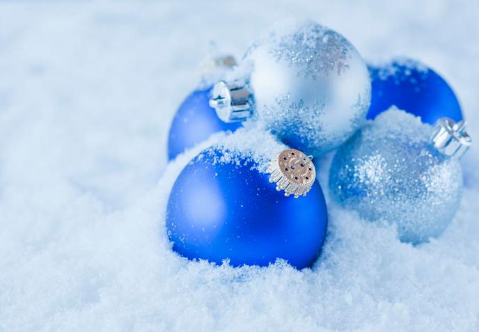 studio-shot-of-blue-and-silver-christmas-ornament-on-snow-daniel-grill.jpg